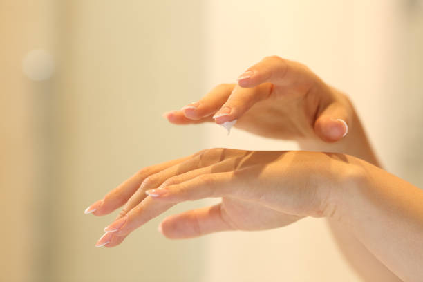 istock Woman hands applying moisturizer cream in the bathroom 1325920311
