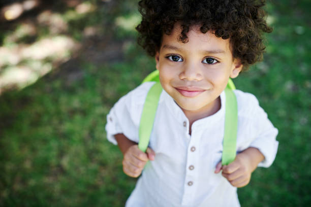 Shot of a little boy wearing a backpack in nature I'm ready! preschool stock pictures, royalty-free photos & images