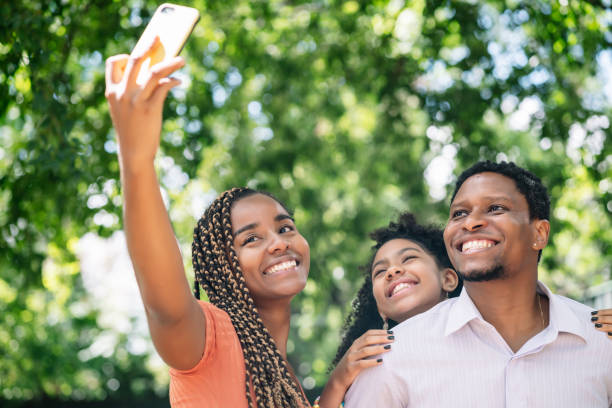 istock Family taking a selfie with a mobile phone at the park. 1325921883