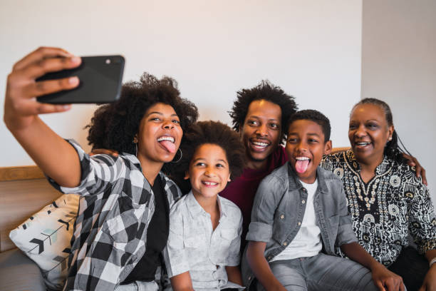 istock Multigenerational family taking selfie with phone at home. 1325923100