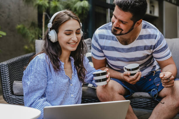 istock Young couple relaxing at home and using laptop 1325923500