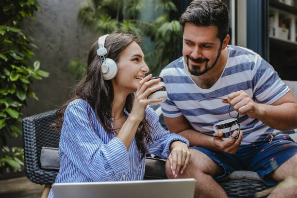 istock Young couple relaxing at home and using laptop 1325923680