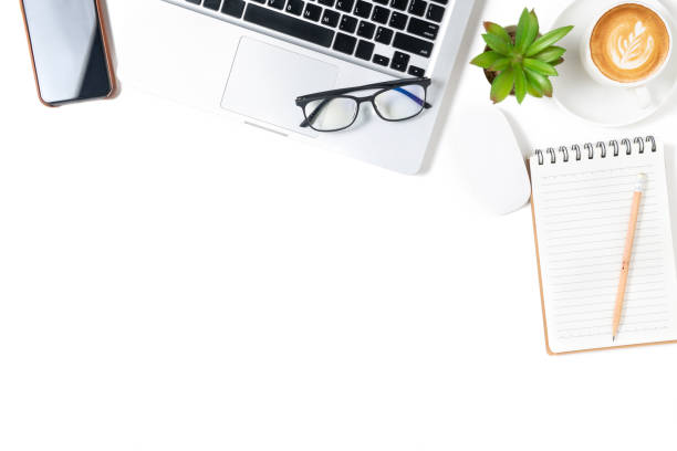 istock White office desk table, Blank notebook with laptop and coffee. 1325924283