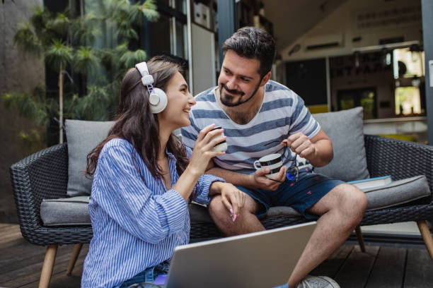 istock Young couple relaxing at home and using laptop 1325924418
