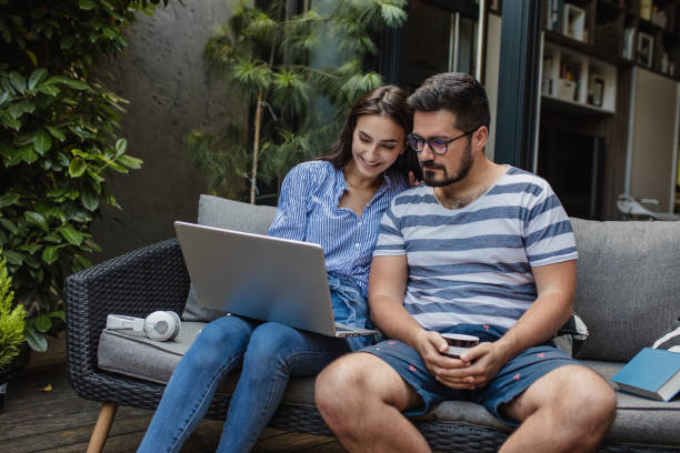 istock Young couple using laptop at home 1325924446