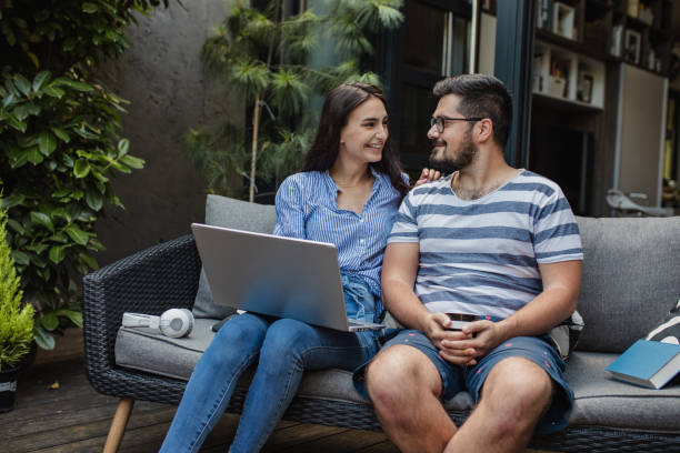 istock Young couple using laptop at home 1325924462