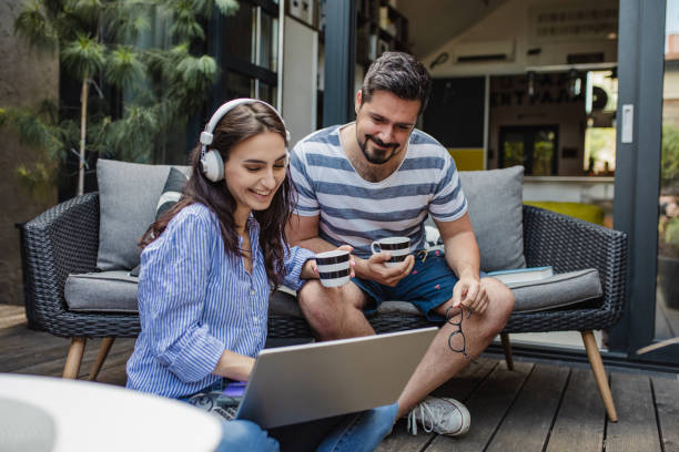 istock Young couple relaxing at home and using laptop 1325924463