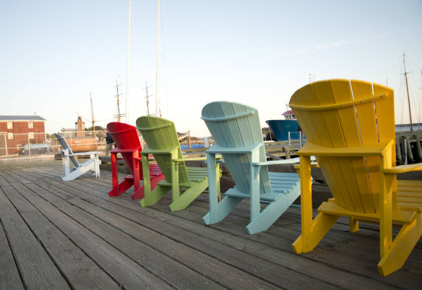 istock Adirondack chairs on a wooden pier. 1325926297
