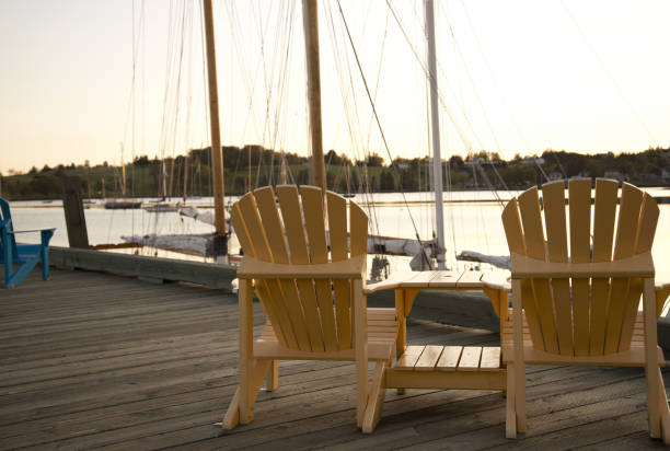 istock Adirondack chairs on a wooden pier. 1325926324