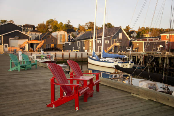 istock Adirondack chairs on a wooden pier. 1325926348