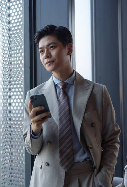 istock Asian businessmen using mobile phones 1325927410