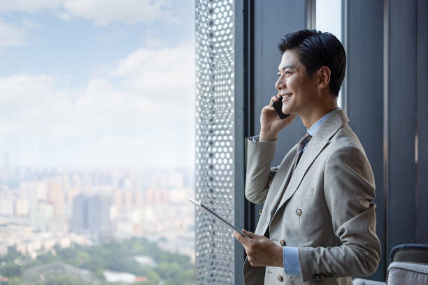 Asian businessmen using mobile phones