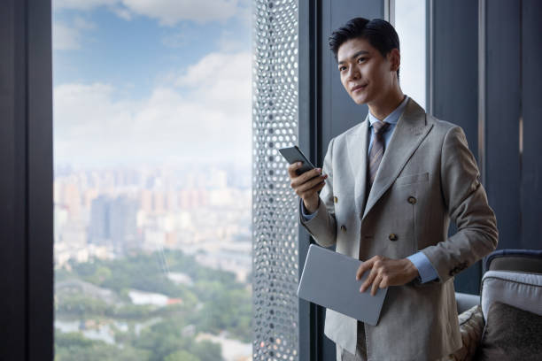 istock Asian businessmen using mobile phones 1325927467
