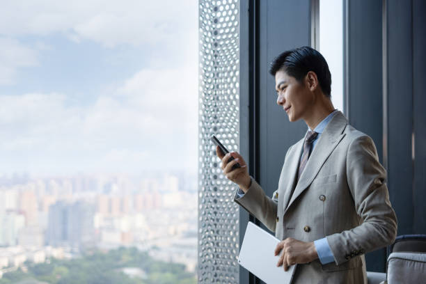 istock Asian businessmen using mobile phones 1325927516