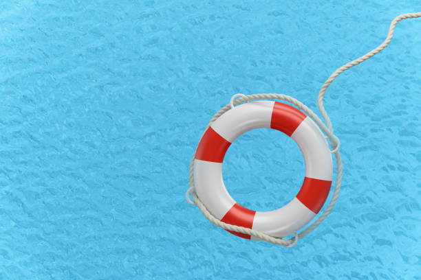 istock Lifebuoy on blue water surface 1325929119