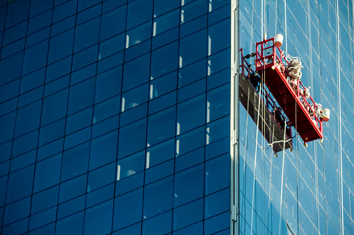 Window cleaning scaffold hanging on a building