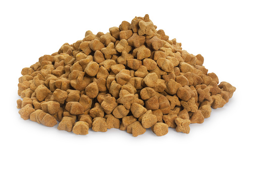 A pile of dry dog food cut out against a white background.