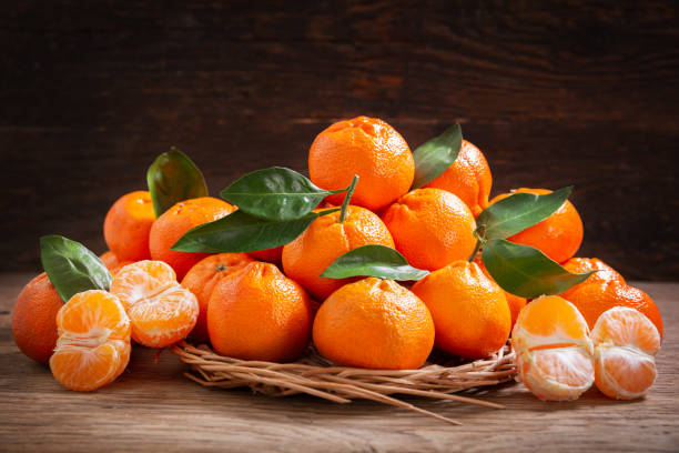 istock Fresh mandarin oranges fruit or tangerines on a wooden background 1325931455