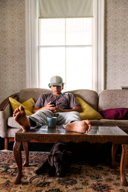 istock Teen boy at home using his phone 1325932647