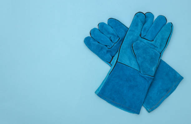 istock Work gloves on a blue background with copy space. Top view 1325932785