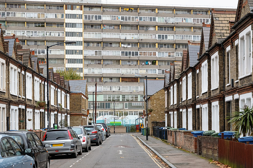 Traditional English terraced houses with huge council block Taplow House of the Aylesbury Estate in the background in south east London