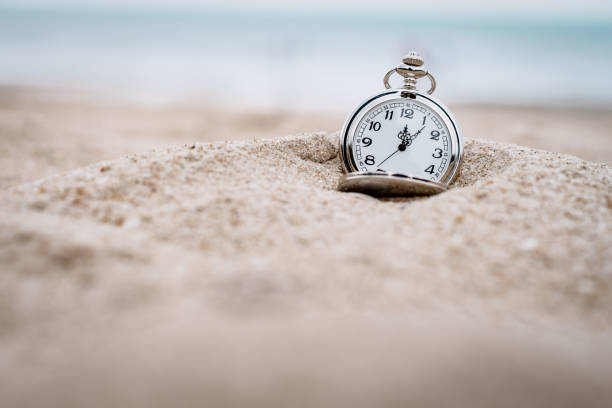 istock Vintage,retro pocket watch on the beach 1325932978
