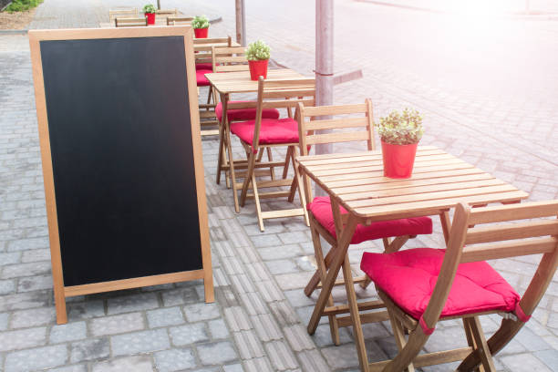 istock Mockup template with summer outside cafe seating setting place and blank black menu charcoal board 1325940243