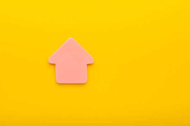 istock House figure on yellow colored paper with free space for advertisement text. 1325940512