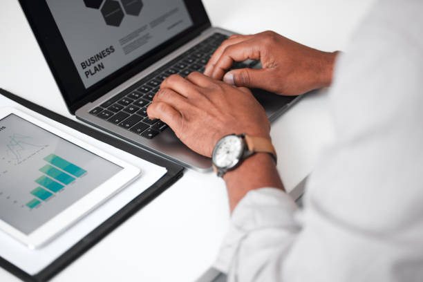 istock High angle shot of an unrecognizable businessman using a laptop while sitting at his desk in the office 1325942007