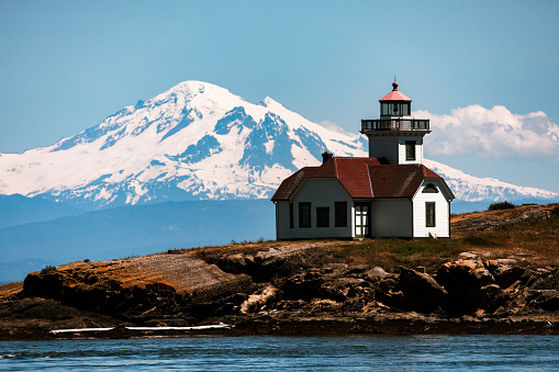 A view of Patos Island Light House at Alden Point in the Puget Sound with Mount Baker in distance.  A wonderful Pacific Northwest view in Washington State.