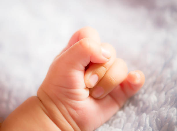 istock Baby Hand Closeup 1325945036