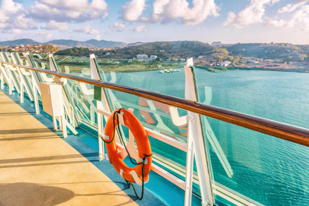 Cruise ship vacation travel caribbean destination Cruise ship vacation travel Caribbean destination. View of island from boat balcony deck with railing and red lifebuoy. Tropical vacation getaway on sea. cruising stock pictures, royalty-free photos & images