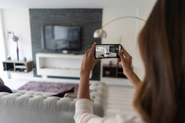 agente de bienes raíces haciendo un recorrido virtual por una casa usando su teléfono celular - lista fotos fotografías e imágenes de stock