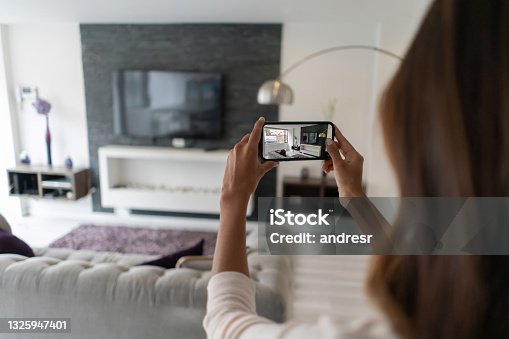 istock Real estate agent making a virtual tour of a house using her cell phone 1325947401