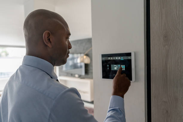 real estate agent locking the door of a house using a home automation system - security home bildbanksfoton och bilder