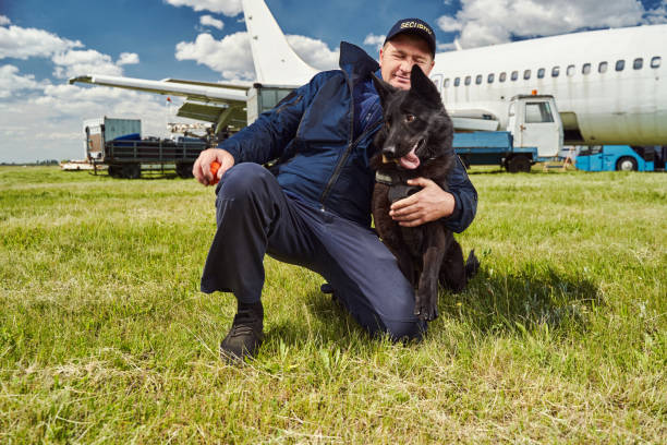 istock Male security officer hugging detection dog at airfield 1325948719