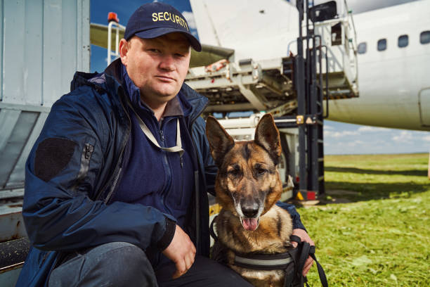 istock Male security guard hugging dog at airfield 1325948741