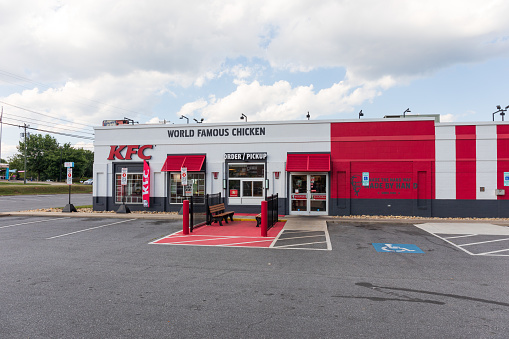 Morganton, NC USA-23 June 2021: A bright, freshly painted red and white KFC (Kentucky Fried Chicken) building.