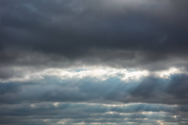 istock Background with stripes of thunderstorm clouds and sunlight rays 1325949092