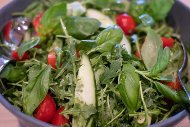 istock Fresh green mixed salad bowl with tomatoes. 1325949722
