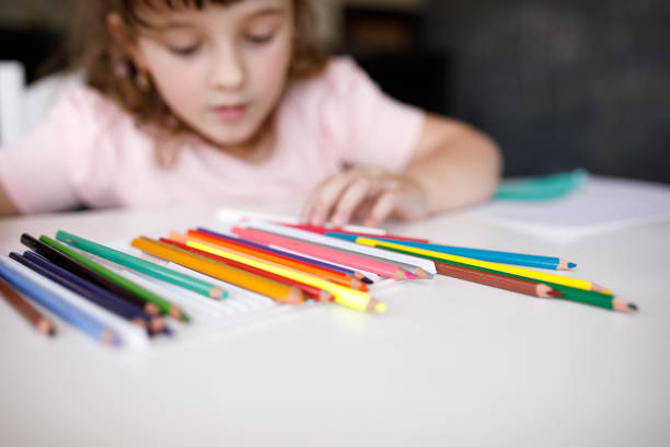 istock Girl choosing a colored pencil to use 1325949790
