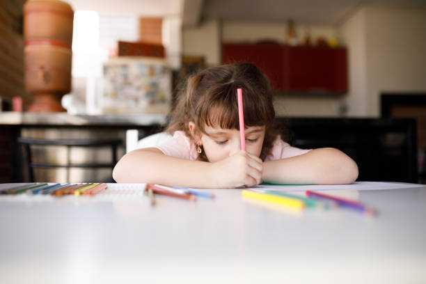 istock Child coloring drawing with head resting on the table 1325949849