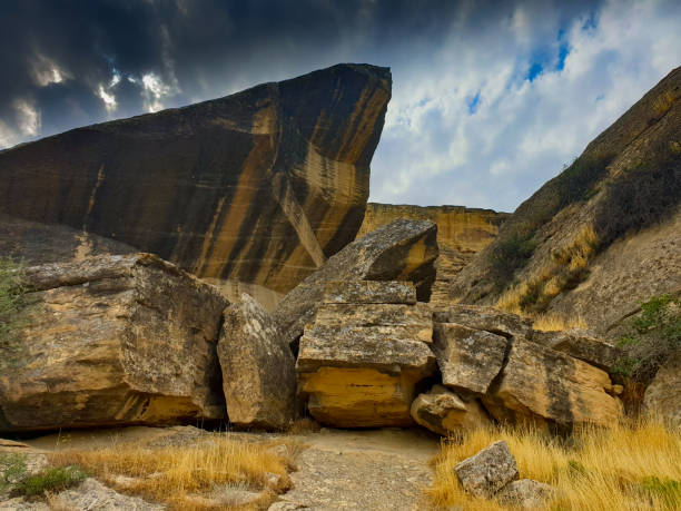 Gobustan national park ancient rocks, rock path and mountains near Baku in Azerbaijan. Exposition of Petroglyphs in Gobustan near Baku, Azerbaijan stock photo