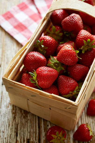 istock Fresh strawberries in the basket on a wooden table 1325953965