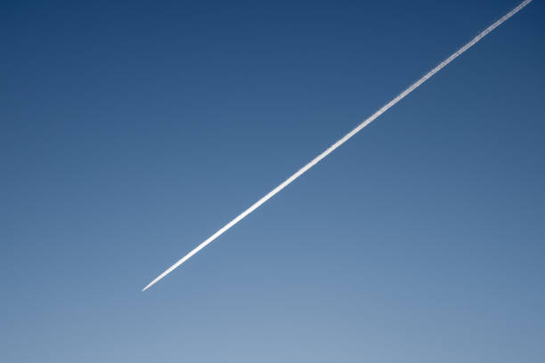 White trace of jet airplane in deep blue sky