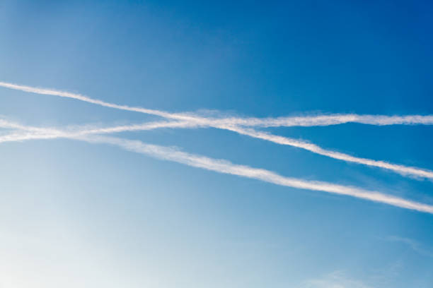Blue sky with airplane trails and clouds. Blue sky with many clouds lines made of aircraft