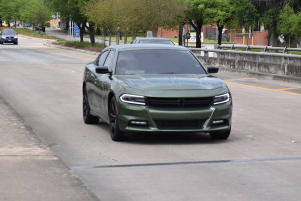 Emerald Green Dodge Charger on Bridge in Houston TX Dodge Charger headed in the direction of William Hobby Airport on Broadway Street in Houston TX. June 2021 dodge charger stock pictures, royalty-free photos & images