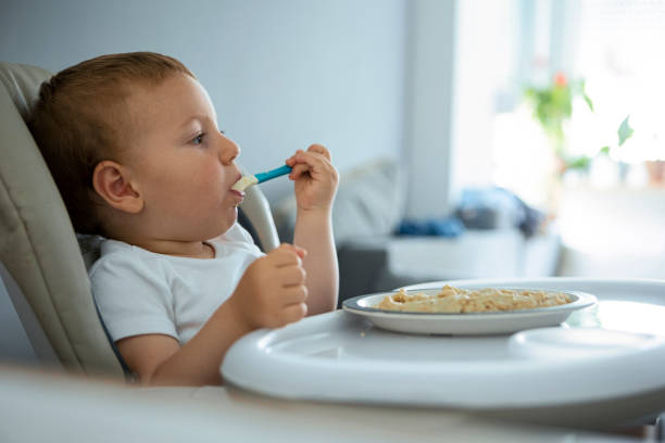 istock Little baby are eating with spoon 1325959644