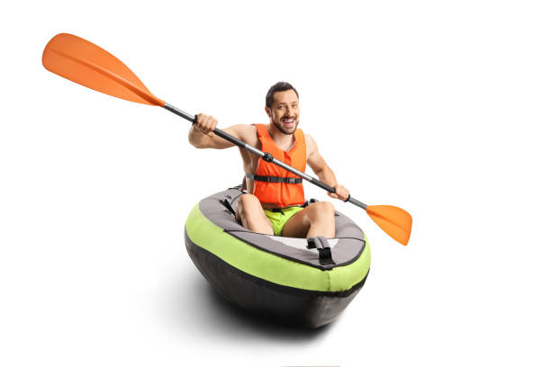 istock Smiling young man in a canoe with a life vest and a paddle 1325961607