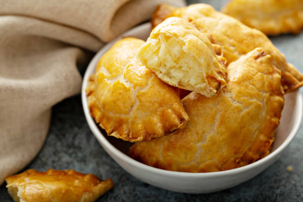 Hand pies with potato filling Hand pies, pasties, samosas or pierogies with potato filling golden baked savory food photos stock pictures, royalty-free photos & images